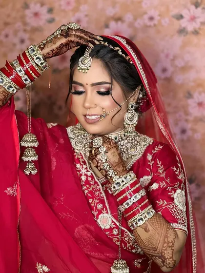 A bride in classic red, showcasing a beautiful white Kundan choker set. This image proves that beauty shines through, and the right jewellery enhances your confidence.