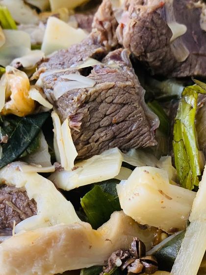 A close-up of the tender beef and 'züsem' (a type of Naga ingredient).