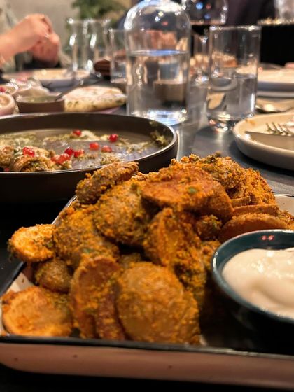 A hearty spread of Indian appetizers at Staple Delhi. This shot is composed to look abundant and inviting, perfect for a family celebration.