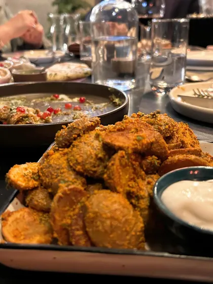 A hearty spread of Indian appetizers at Staple Delhi. This shot is composed to look abundant and inviting, perfect for a family celebration.