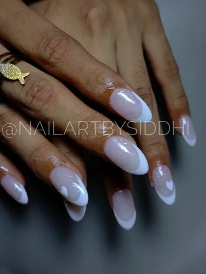 A cute take on the classic French, with a delicate white heart painted on the accent nail.