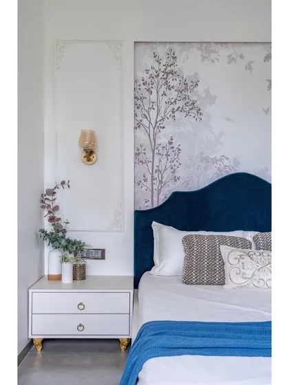 This close-up shows the fine craftsmanship of the wall moulding and the custom bedside table with elegant legs. We believe luxury lies in these well-executed details.