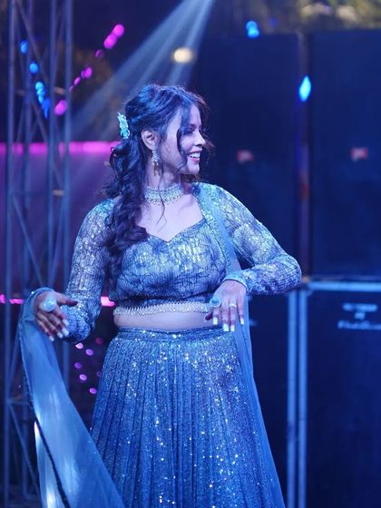 A candid shot of the bride during her solo performance, looking radiant and happy.