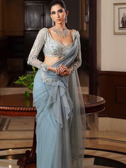 A full-length view of the reception look, showing the elegant grey saree and the way the makeup ties the whole look together.