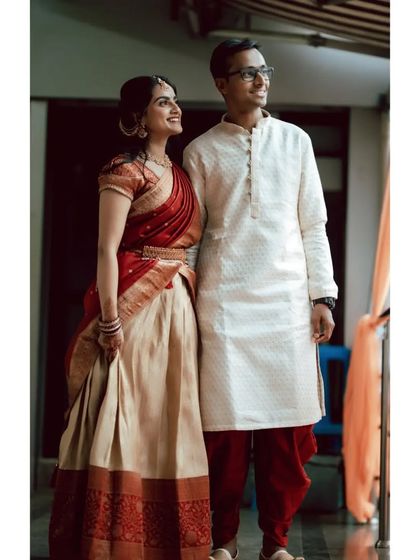 A happy portrait of a couple on their engagement day, dressed in beautiful traditional South Indian attire.