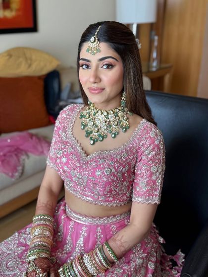 A smiling portrait of the bride in her pink lehenga. I teach how to create makeup that radiates joy and confidence.