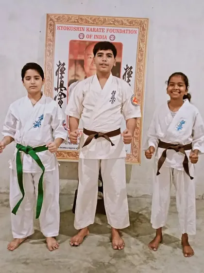 My senior students, two brown belts and a green belt, ready to take on new challenges.