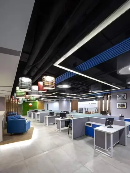 Here is a look at a complete open-plan office I designed. The layout includes modular workstations for focused tasks, a comfortable breakout area with the blue sofa for informal meetings, and carefully planned lighting to create a productive atmosphere.