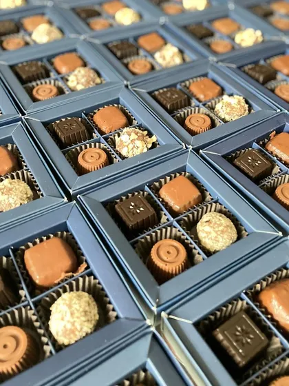 Inside our corporate gift boxes for CMRIT. A curated selection of six different artisanal chocolates to welcome new team members.
