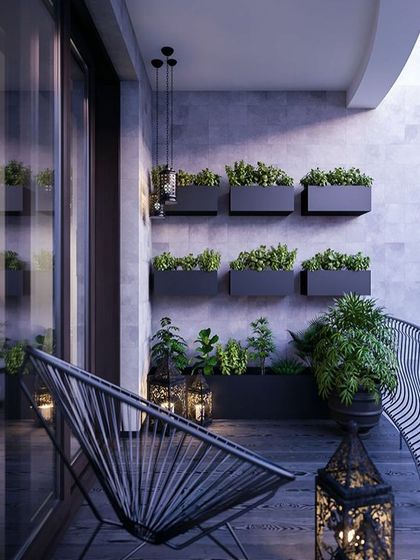 A clean and modern balcony design. The use of wall-mounted planters for a vertical garden saves floor space, while the minimalist chair and lanterns add a touch of style.