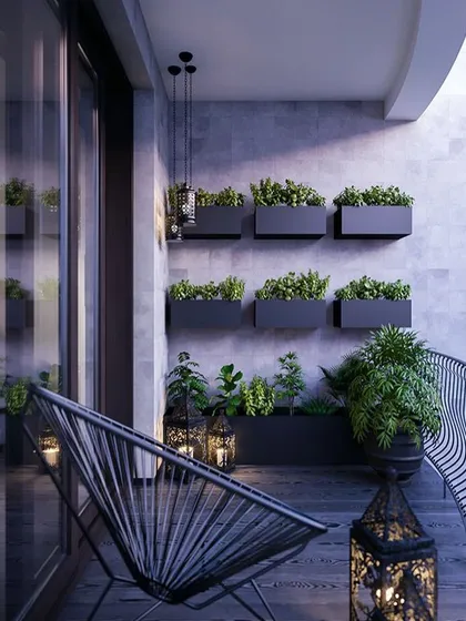 A clean and modern balcony design. The use of wall-mounted planters for a vertical garden saves floor space, while the minimalist chair and lanterns add a touch of style.