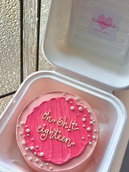 A cheeky bento cake for an 18th birthday. The combination of bright pink, pearls, and a fun message makes it perfect for the occasion.