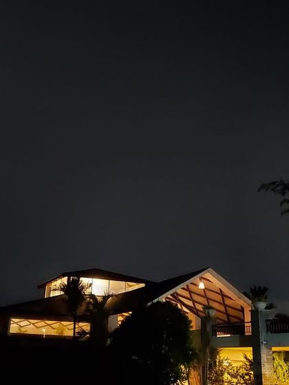 The main building seen at night, its warm lights offering a sense of comfort and safety. This image conveys the feeling of being in a protected, nurturing space, even after dark.