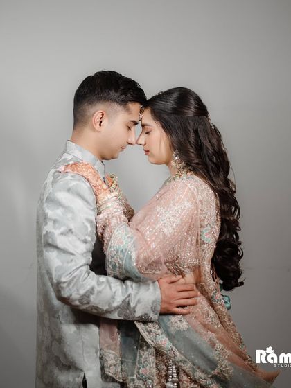 A deeply romantic and intimate close-up portrait. The soft lighting and the couple's foreheads touching create a powerful image that speaks of trust, love, and a shared future.