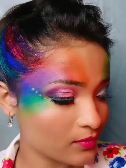 A close-up of my Holi-inspired makeup, showcasing a rainbow of colors blended across the forehead and eyes, accented with glitter for a festive sparkle.