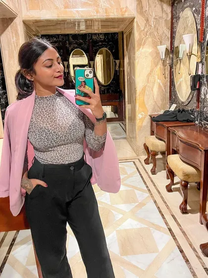 Power dressing is all about confidence. I styled this look with a soft pink blazer draped over a patterned top and classic black trousers, perfect for making a statement in a corporate or creative setting.