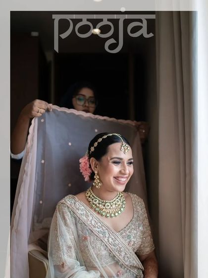 A behind-the-scenes moment of the bride getting her veil adjusted, her joyful smile lighting up the frame.