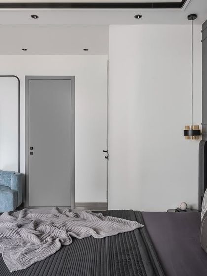 A comfortable blue couch creates a cozy reading nook within the master bedroom. This versatile addition provides a perfect spot for relaxing with a book or enjoying a quiet moment away from the main living areas.