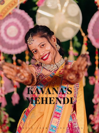 A portrait of a bride showing off her beautiful mehendi during her colorful Mehendi ceremony.
