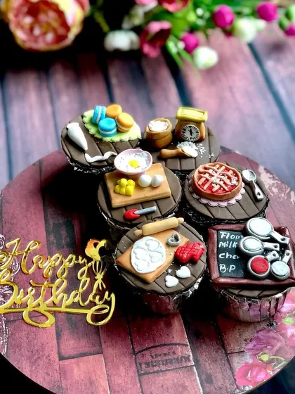 My custom cupcakes are tiny canvases for edible art. This set was designed for a fellow baker, featuring incredibly detailed, handmade fondant toppers that represent the tools of our trade, from a miniature pie and macarons to a tiny scale and rolling pin.