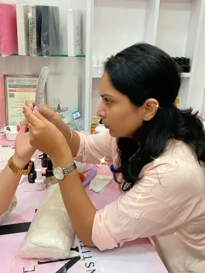 A student practices filing and shaping, a critical skill for achieving professional results.