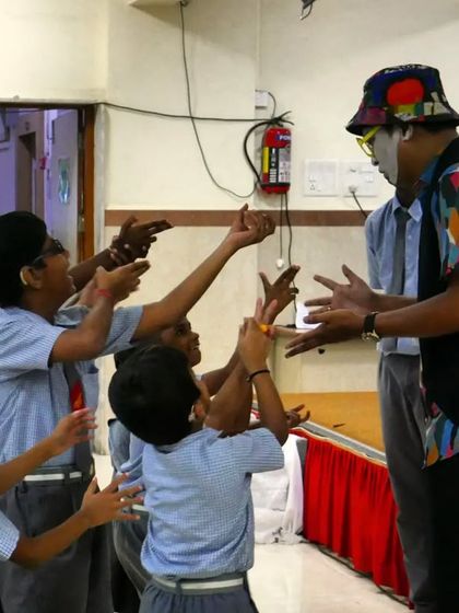 Children reach out to the 'Silent Storyteller', eager to be part of the act. His interactive performance breaks down barriers and invites everyone to join in the fun.