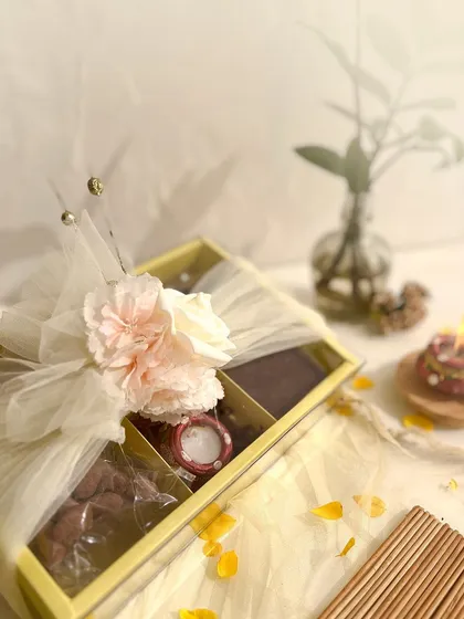 Our medium-sized Diwali hamper, featuring a Belgian chocolate brownie, choco almonds, hazelnut cookies, and two decorative diyas.