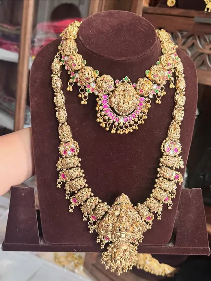 Just look at the incredible detail on this antique gold replica bridal set. The layered harams feature goddess motifs, giving you that authentic, royal South Indian bride look that I absolutely adore.
