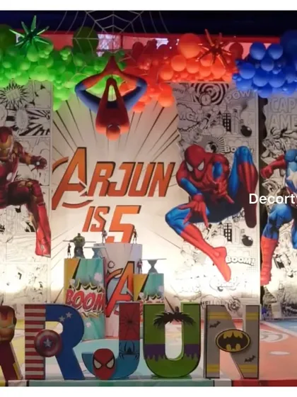The main stage backdrop with dramatic lighting, featuring Iron Man, Spider-Man, and Captain America.