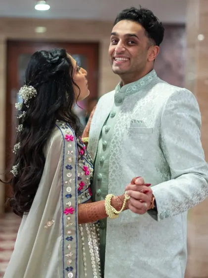 A candid, happy moment between the couple during their Mehendi event. The groom's expression is priceless.