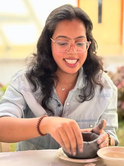 The joy of making something with your own hands is universal. A smiling participant from the Tata Memorial Centre enjoying a sunny afternoon of creativity.
