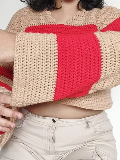 A close-up of the flared bell sleeves, a key feature of this sweater design.
