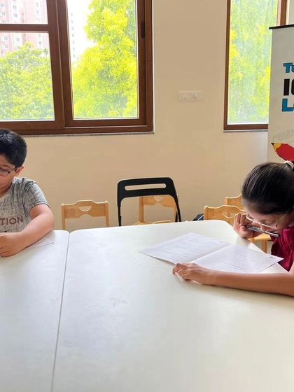Two students deeply engrossed in their IRO entrance test papers. This test is a critical gateway for joining our advanced Olympiad preparation batches.