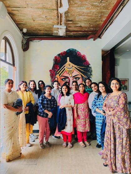 The ladies from the college reunion posing in front of our signature mural. My restaurant's artistic details provide a great backdrop for group photos and memories.