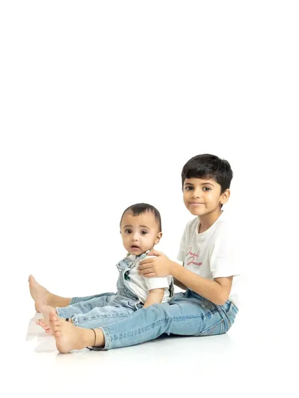 The sweet bond between brothers. We aim to capture the gentle and protective nature of sibling relationships in our studio portraits.