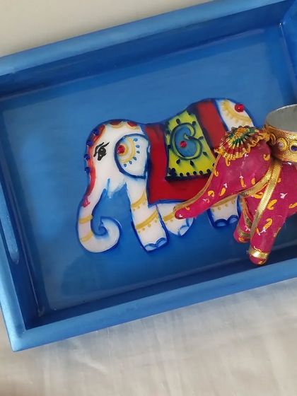 Another custom gift set, this time featuring a blue tray with a hand-painted elephant and a matching decorative elephant T-light holder. It's a charming and coordinated gift for any occasion.