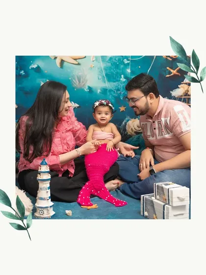 The whole family joins in for the fun! A six-month milestone shoot becomes a cherished family portrait with mom and dad admiring their little mermaid.