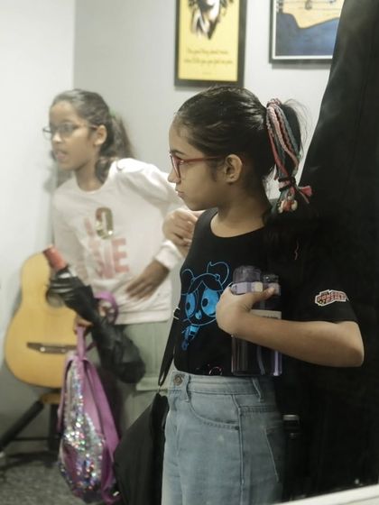 Students arriving for their guitar class, carrying their instruments and ready to learn. The journey begins the moment they walk through our doors.