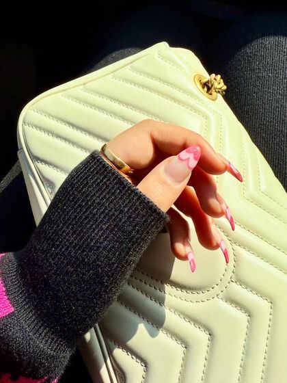 A closer look at our heart-tipped Valentine's nails. The unique design and soft pink colour create a chic and romantic statement.