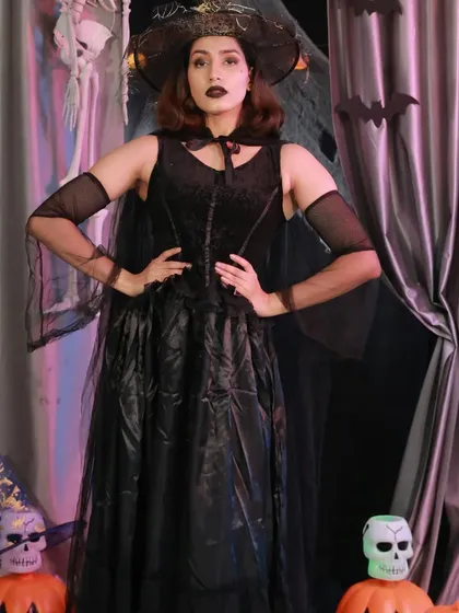 Cast a spell on everyone with this elegant witch costume. The long black dress, sheer cape, and matching hat create a look that is both sophisticated and spooky.