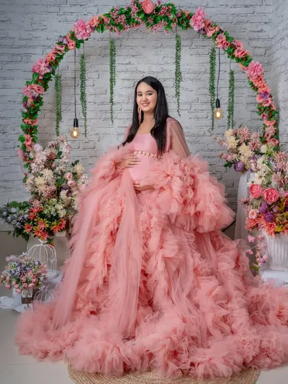 A happy, smiling portrait that captures the pure joy of the mother-to-be in our floral arch setup.