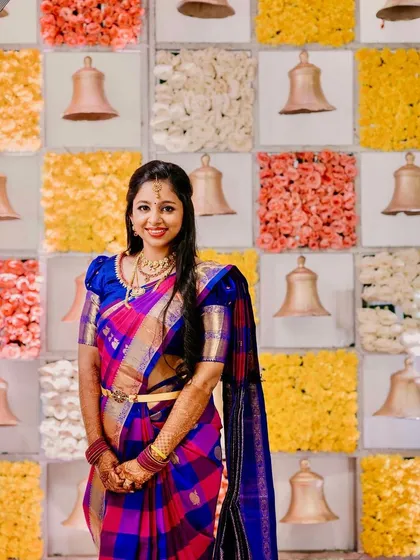 A beautiful portrait of the bride. Her multi-colored saree is so unique, and the makeup complements it perfectly.