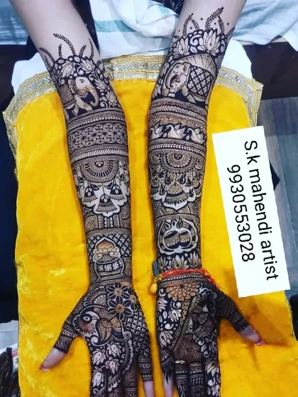 A design filled with auspicious and traditional motifs. It includes elephants, peacocks, kalash, and lotus flowers, creating a very festive look.