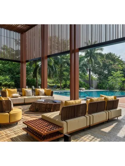 The expansive outdoor lounge area of the 'K House' is designed for entertainment, with comfortable seating overlooking the main swimming pool and lush gardens.
