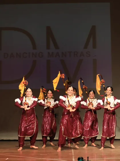 The Bhangra Queens in a powerful starting pose with their props, ready to mesmerize the 'City of Stars' audience.