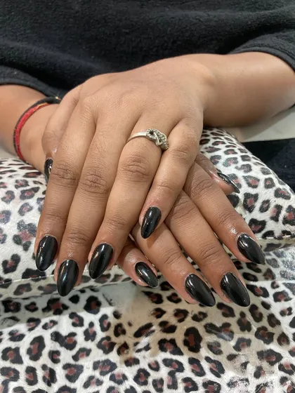 You can never go wrong with a classic. This look features perfectly shaped almond nail extensions with a high-gloss, jet-black gel polish finish. It's a bold, chic, and timeless choice that exudes confidence.