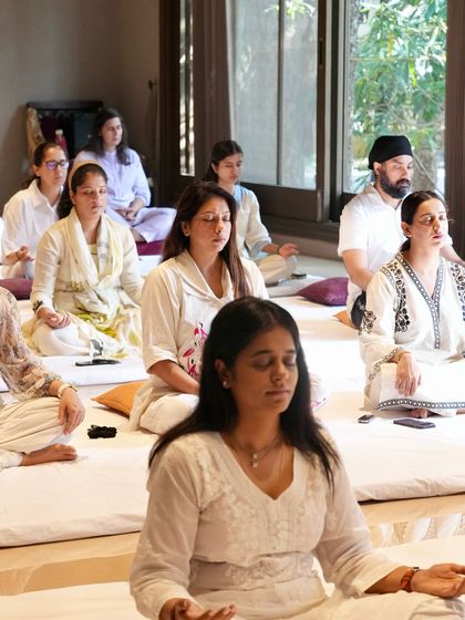 A wide shot of our Sangat in meditation. The collective focus creates a powerful container for healing and spiritual growth.