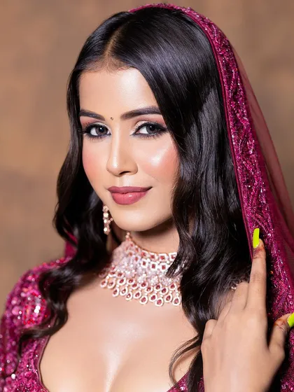 A close-up on a soft glam makeup look, perfectly accented by a delicate diamond and ruby choker set. This beautiful jewellery is available for rent to complete your party look.