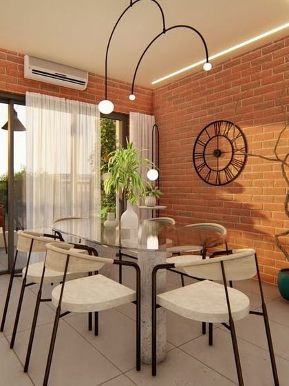 This dining room has an industrial-chic vibe with exposed brick walls and a modern, artistic light fixture. The large artwork adds a pop of color and personality to the eclectic space.