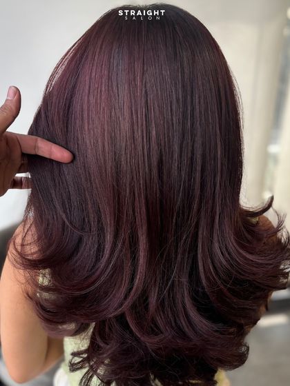 Rich burgundy waves that catch the light just right. This is a perfect example of how color and curls can come together.